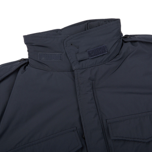 A close up of an Aspesi navy blue Nylon Padded Field Jacket on a white background.