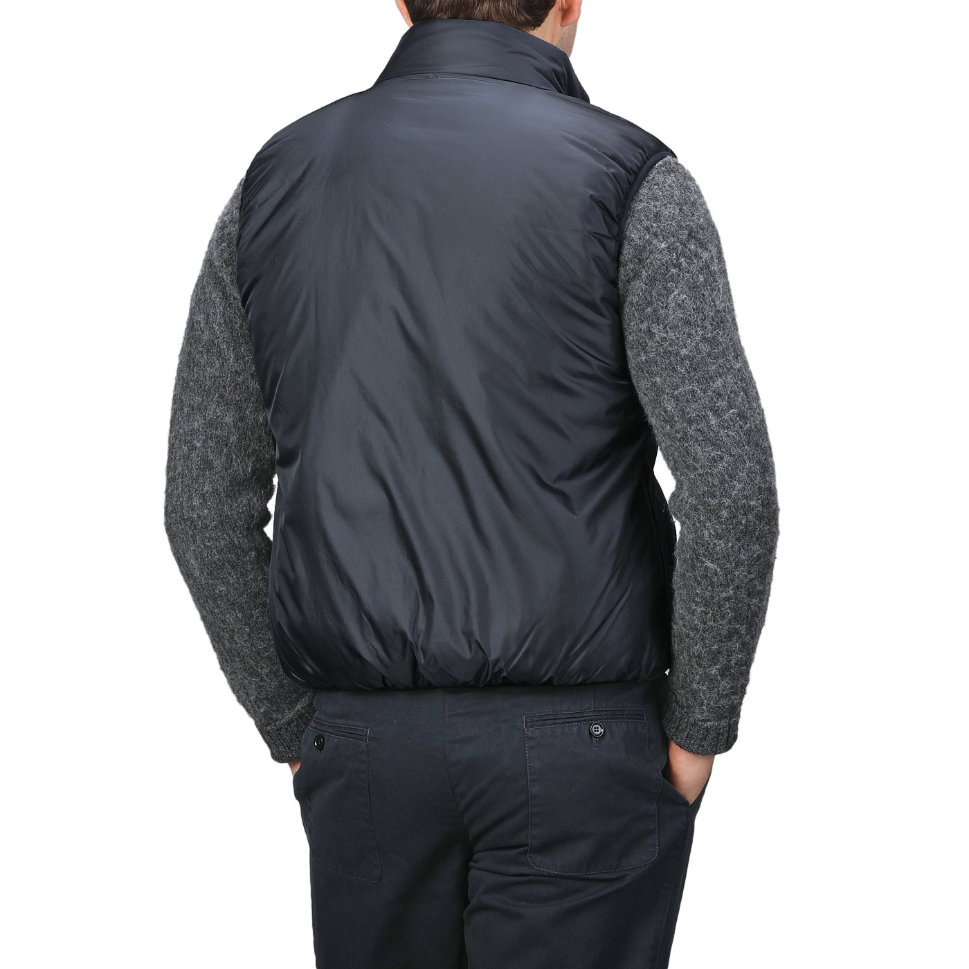 A person wearing an Aspesi Navy Blue Nylon Taffetta Thermore Jil Gilet over a gray sweater and dark pants, viewed from the back.