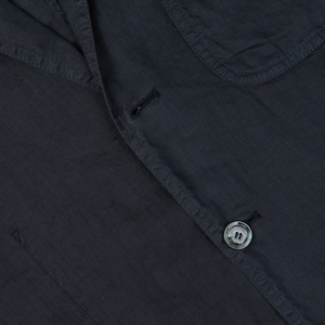 Close-up of a dark Aspesi Navy Blue Washed Linen Samuraki Jacket detailing a buttonhole and a button.