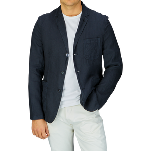 Man wearing an Aspesi Navy Blue Washed Linen Samuraki Jacket over a white t-shirt with light-colored pants.