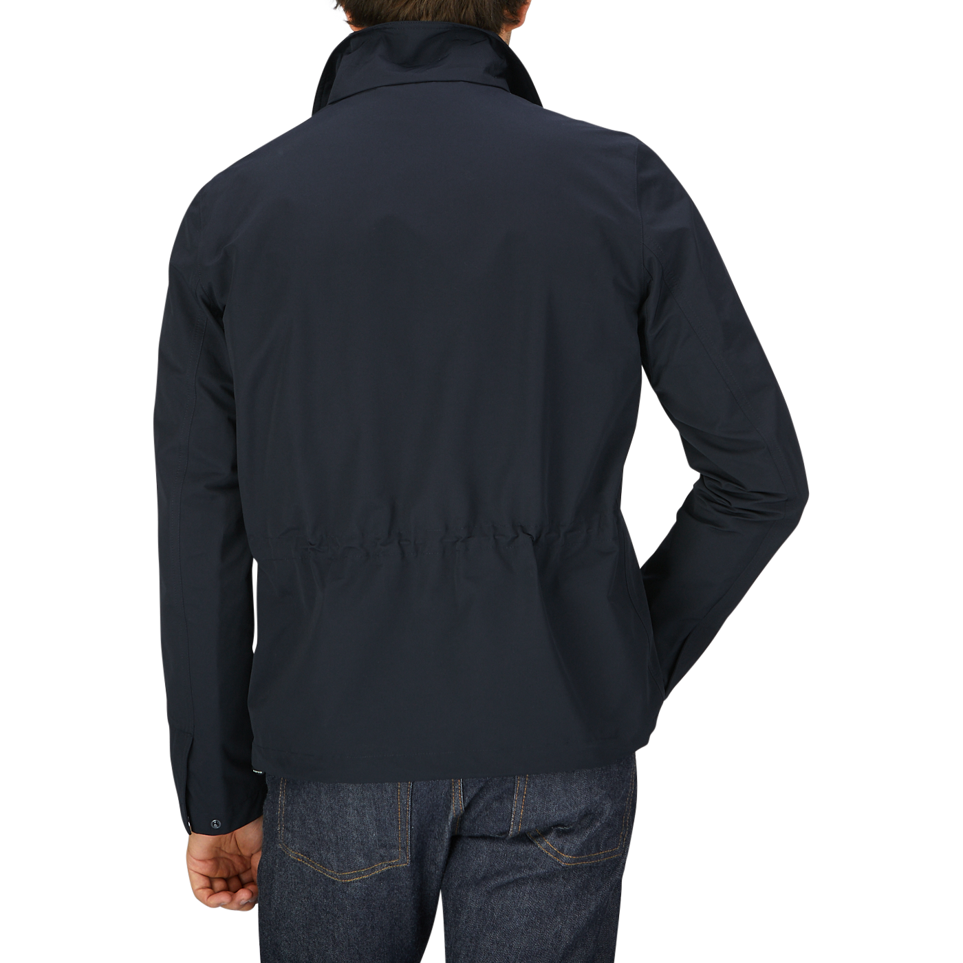 The back view of a man wearing a Aspesi Navy Cotton Canvas Windbreaker Stringa Jacket, a water-resistant jacket.