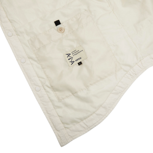 A white quilted Aspesi Off-White Cotton Padded Overshirt with a pocket on it.