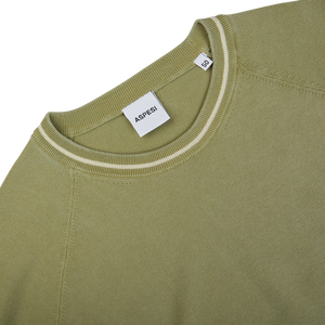 A Aspesi sage green cotton piquet crew neck sweater with a white stripe on the sleeve.