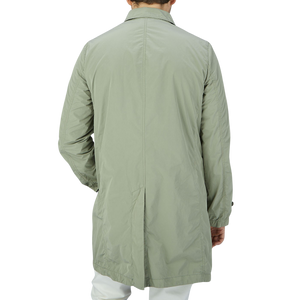 The back view of a man wearing an Aspesi Sage Green Micro Nylon Limone Coat.