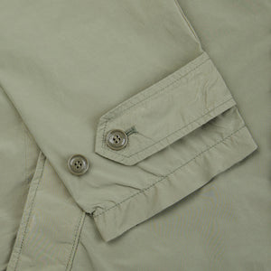 A close up of a lightweight, Aspesi Sage Green Micro Nylon Limone Coat with buttons.
