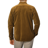 A person is shown from the back wearing an Aspesi Tobacco Brown Cotton Velvet Overshirt paired with beige pants against a plain background.