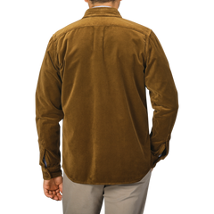 A person is shown from the back wearing an Aspesi Tobacco Brown Cotton Velvet Overshirt paired with beige pants against a plain background.