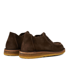 A pair of brown Astorflex suede chukka boots with visible crepe soles.