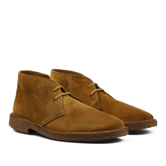 A pair of brown suede Astorflex Montflex desert boots against a neutral background.