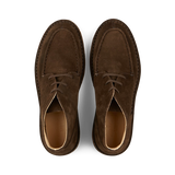 A pair of dark chestnut suede Astorflex Dukeflex Chukka Boots with laces, viewed from above on a plain background.