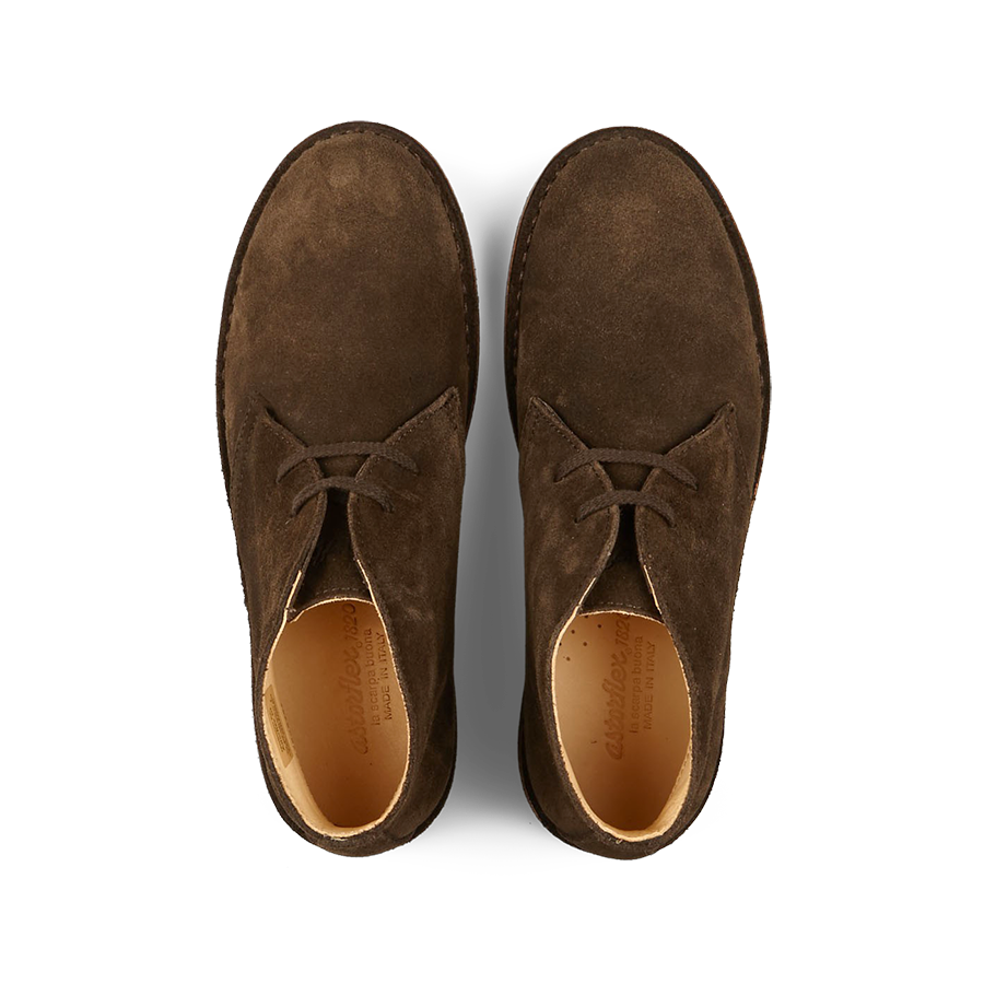 A pair of brown, vegetable-tanned suede Astorflex desert boots. 
Corrected: A pair of Dark Chestnut Suede Greenflex Astorflex desert boots.