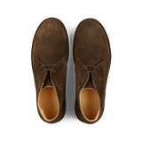 A pair of brown, vegetable-tanned suede Astorflex desert boots. 
Corrected: A pair of Dark Chestnut Suede Greenflex Astorflex desert boots.