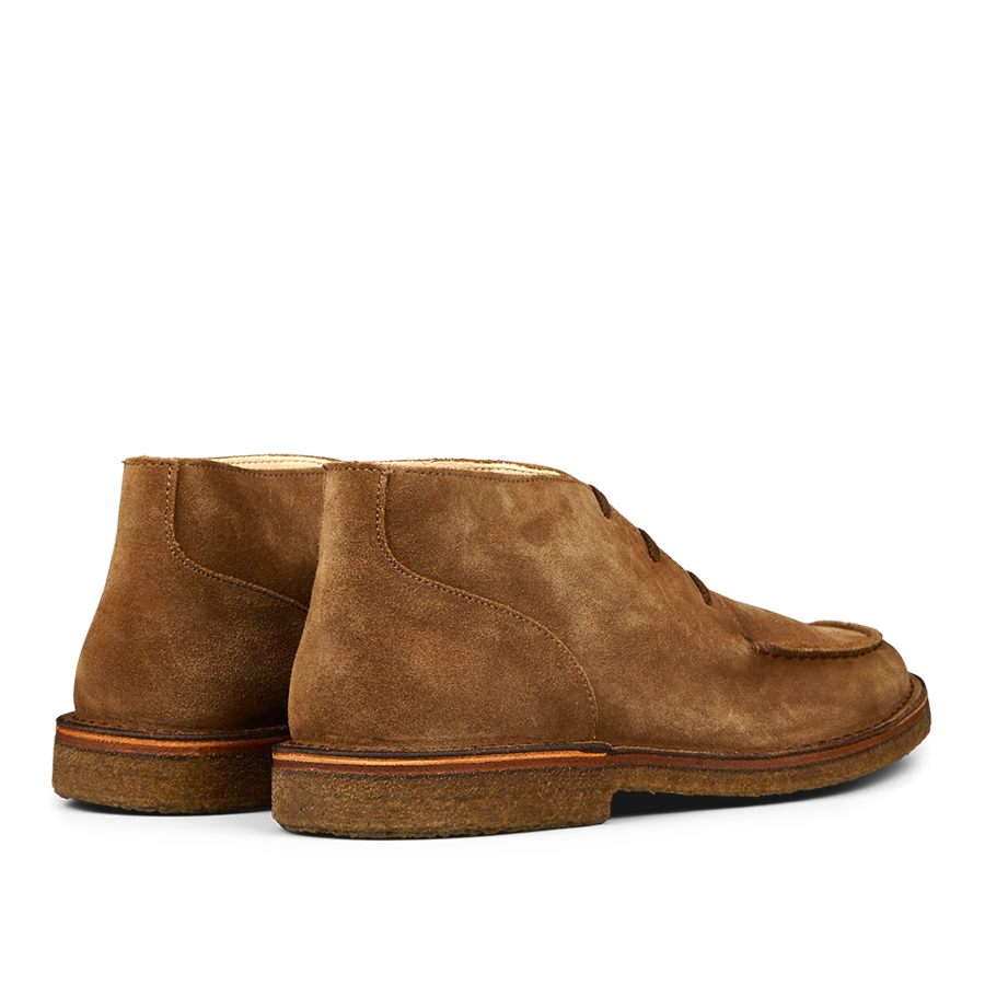 A pair of dark khaki, vegetable-tanned suede Dukeflex chukka boots from Astorflex on a neutral background.