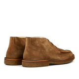 A pair of dark khaki, vegetable-tanned suede Dukeflex chukka boots from Astorflex on a neutral background.