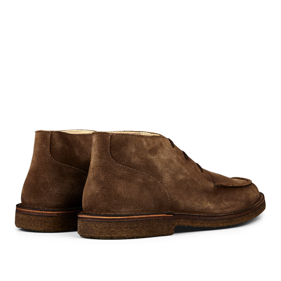 The Dark Khaki Suede Dukeflex Chukka Boots from Astorflex are made from luxurious vegetable-tanned suede leather, showcasing visible stitching and a textured sole for a stylish look. These ankle boots provide the perfect balance of comfort and style.