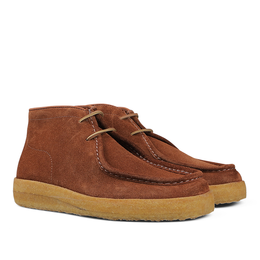 A pair of Astorflex Mattone Brown Suede Rampiflex boots crafted from vegetable-tanned suede, featuring beige natural crepe rubber soles and lace-up closures.