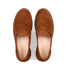 Viewed from above on a white background, the Mattone Suede Leather Buffalo Sadelflex Loafers by Astorflex are made of brown vegetable-tanned suede leather, featuring intricate stitching and perforated insoles.