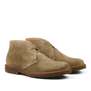 A pair of Stone Beige Suede Greenflex desert boots with laces on a neutral background.