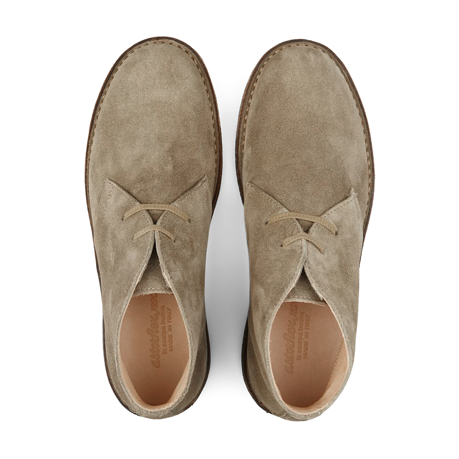 Top view of a pair of Stone Beige Suede Greenflex Desert Boots by Astorflex, featuring tan leather lining and crepe rubber soles.