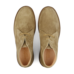 A pair of stone beige vegetable-tanned suede Astorflex Greenflex desert boots with laces, viewed from above.