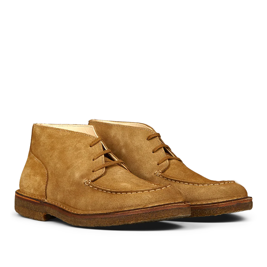 A pair of Whiskey Beige suede Dukeflex Chukka boots by Astorflex, crafted from vegetable-tanned suede with textured soles, displayed side by side on a white background, offers both style and comfort.