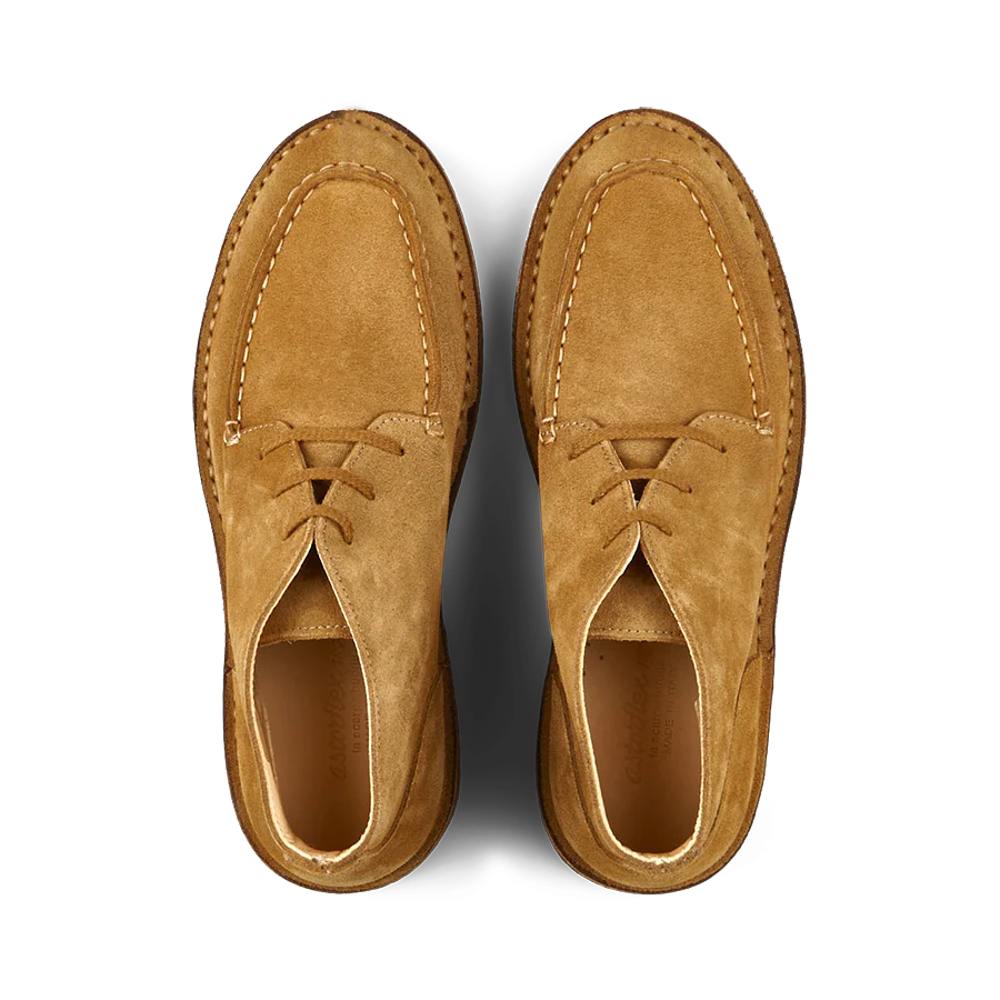 Top view of a pair of Astorflex Whiskey Beige Suede Dukeflex Chukka Boots, made from vegetable-tanned suede with visible stitching details, on a white background.