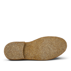 A single brown cork shoe insole for a Astorflex Whiskey Beige Suede Greenflex Desert Boot isolated on a transparent background.