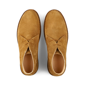 A pair of whiskey beige suede Astorflex Greenflex Desert Boots displayed from a top-down view on a transparent background.