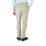 The man in the Beige Melange Wool Linen Pleated Trousers by Baltzar Sartorial has tailored trousers.