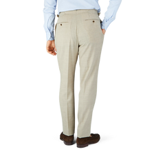 The man in the Beige Melange Wool Linen Pleated Trousers by Baltzar Sartorial has tailored trousers.