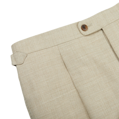 A close up of Beige Melange Wool Linen Pleated Trousers made by Baltzar Sartorial.