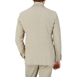 The back view of a man wearing a Baltzar Sartorial Beige Melange Wool Linen Suit Jacket.