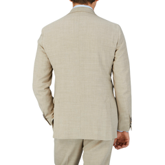 The back view of a man wearing a Baltzar Sartorial Beige Melange Wool Linen Suit Jacket.