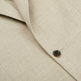 A close up of a Baltzar Sartorial Beige Melange Wool Linen Suit Jacket with pleated trousers and buttons.