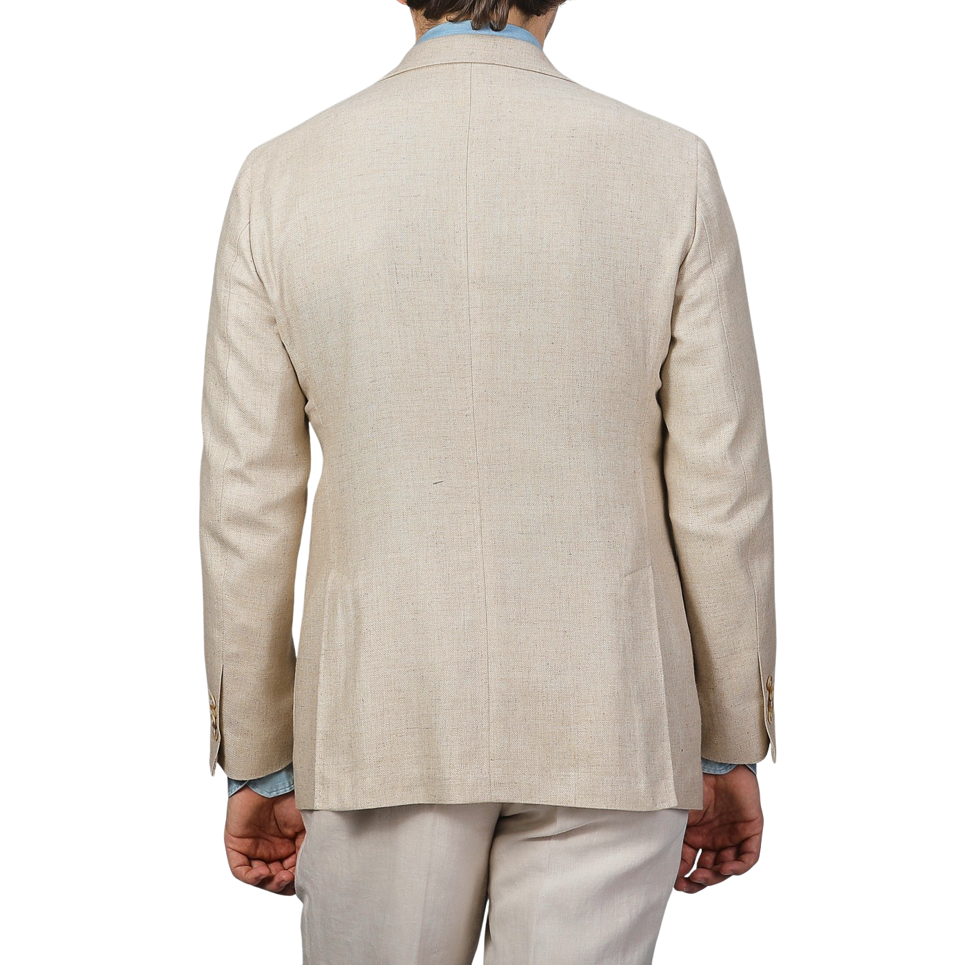 Rear view of a person in a Baltzar Sartorial Beige Wool Silk Summer Tweed Blazer and pants, with light blue shirt cuffs visible, against a plain background.