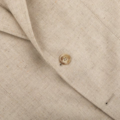 Close-up of the Beige Wool Silk Summer Tweed Blazer by Baltzar Sartorial, highlighting its texture with one visible button and a pocket seam.