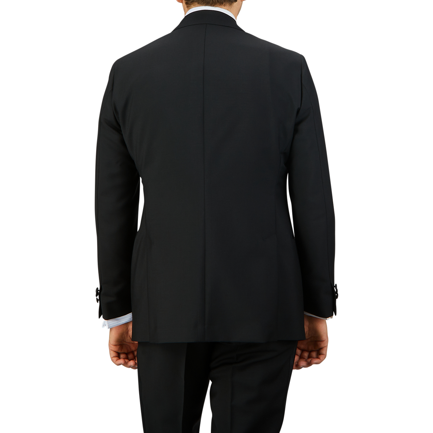 Back view of a person wearing a Black Wool Mohair Tuxedo Jacket by Baltzar Sartorial and matching pants.