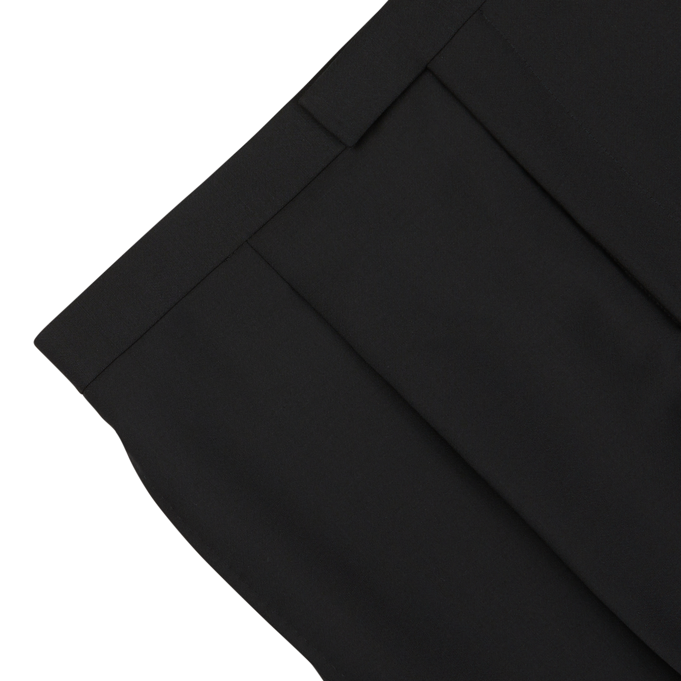 Close-up view of the waist and pleated front of a pair of Baltzar Sartorial Black Wool Mohair Tuxedo Pleated Trousers against a white background, showcasing their formal look.