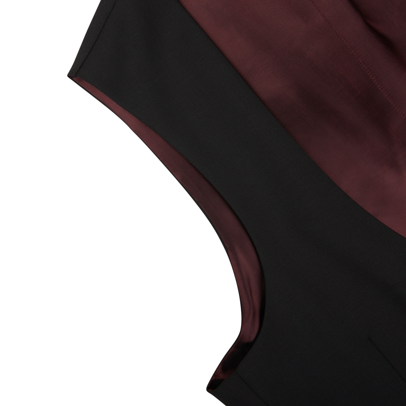 Close-up of a Black Wool Mohair Tuxedo Waistcoat from Baltzar Sartorial, featuring a maroon interior lining that beautifully highlights the contrast between the fabrics. The wool-mohair blend provides an elegant sheen and refined texture to the garment.