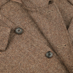 Close-up of the Brown Herringbone Wool Tweed Utility Jacket by Baltzar Sartorial, featuring black buttons and buttonholes, providing a stylish alternative to a casual blazer.