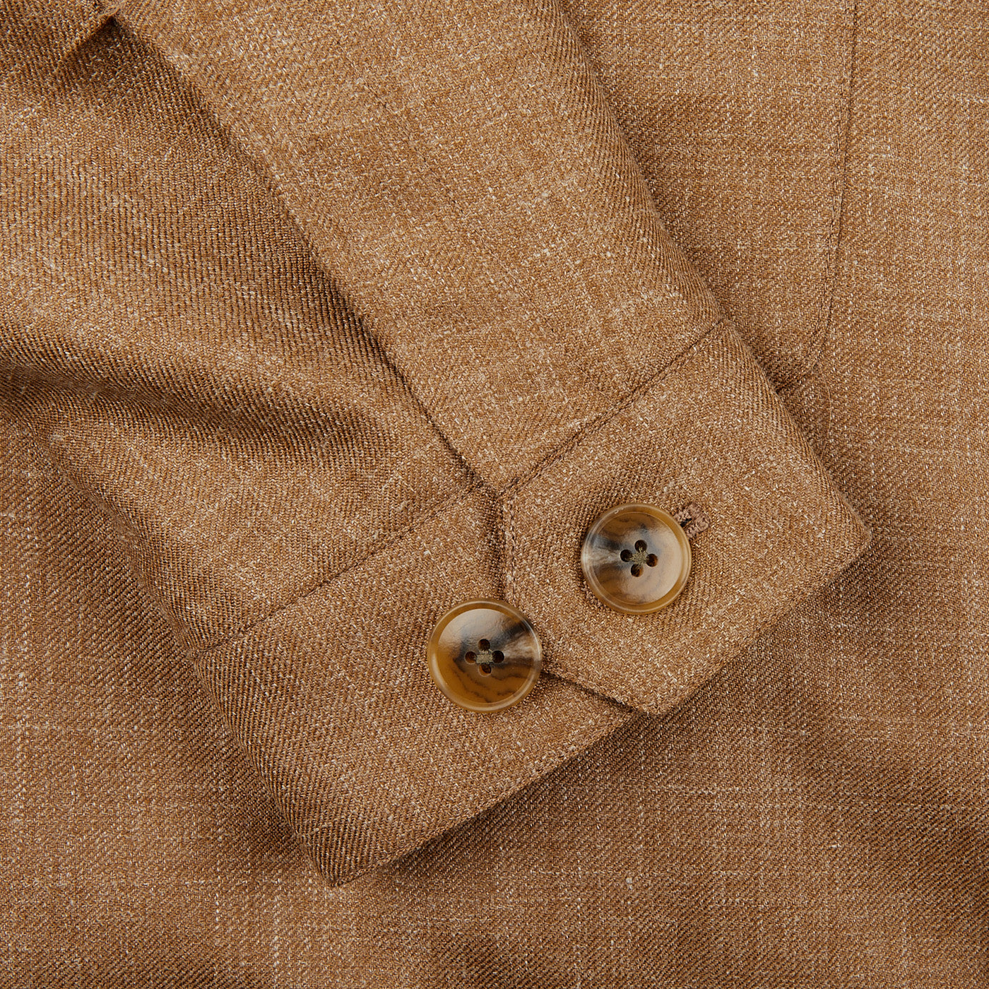 Close-up of the Camel Brown Wool Silk Linen Safari Jacket sleeve featuring two brown cuff buttons, highlighting Baltzar Sartorial's refined design.