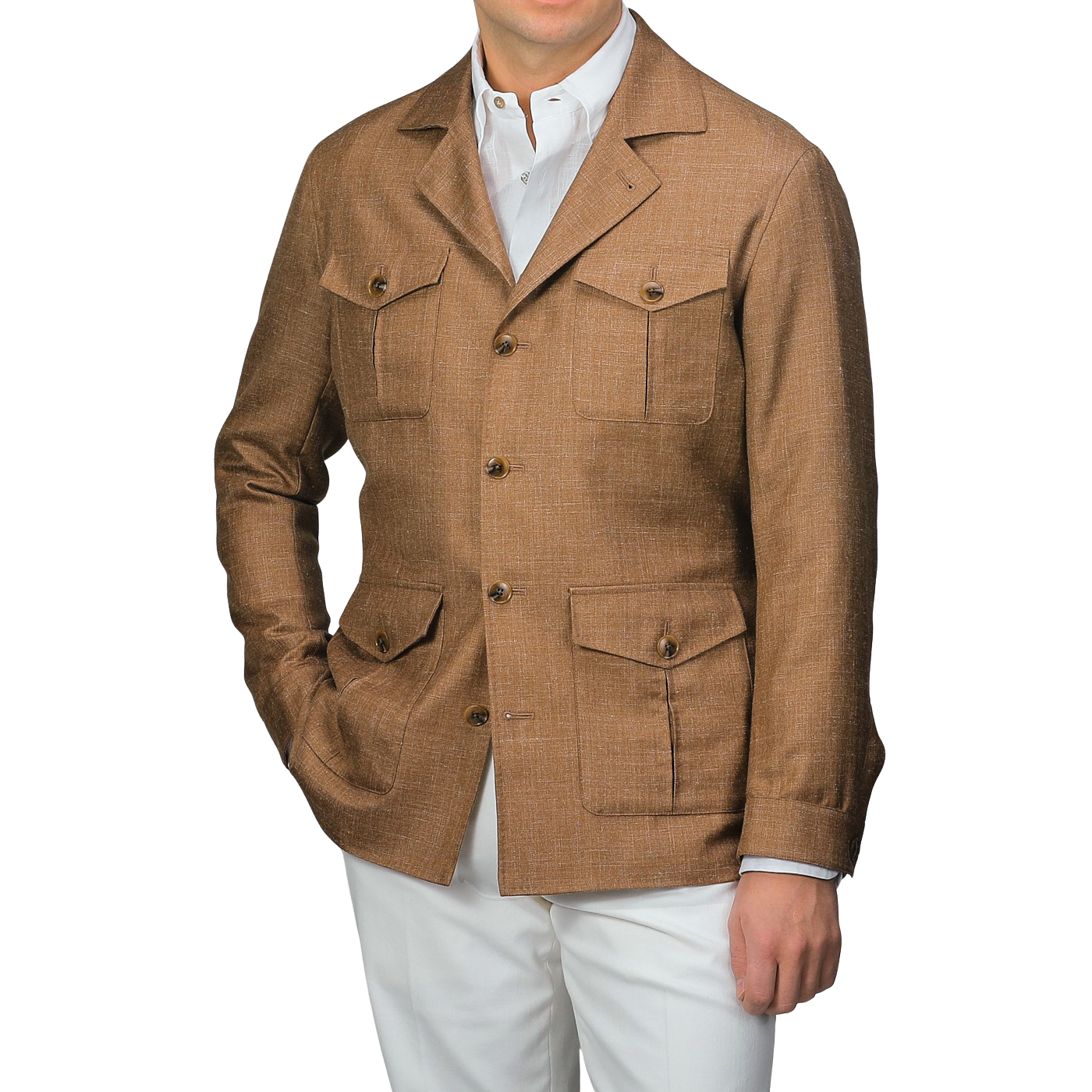 A man wearing a Baltzar Sartorial Camel Brown Wool Silk Linen Safari Jacket with four pockets and white pants stands against a neutral background, effortlessly showcasing a stylish tailored blazer substitute.