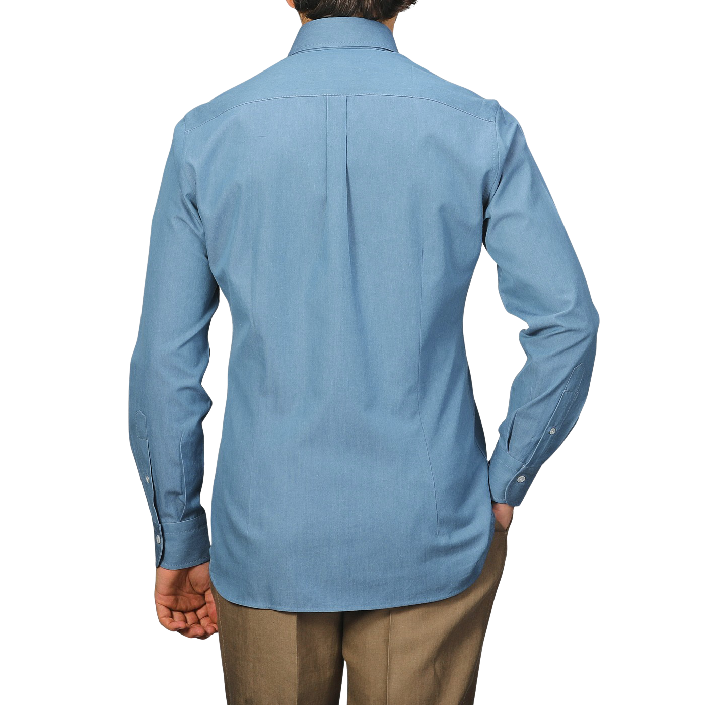 A person is facing away from the camera, wearing the Denim Blue Cotton Twill BD Western Shirt by Baltzar Sartorial with beige pants. Its regular fit and pure cotton twill enhance its classic appeal.