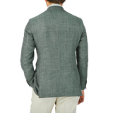 The back view of a man wearing a Baltzar Sartorial Green Melange Wool Silk Linen Blazer.