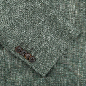 A close-up of a Green Melange Wool Silk Linen Blazer with notch lapel, made from a wool blend fabric by Baltzar Sartorial.