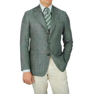 A man in a Baltzar Sartorial Green Melange Wool Silk Linen Blazer and white shirt.