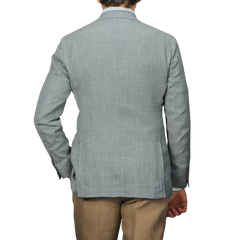 A person is shown from the back against a neutral background wearing a Baltzar Sartorial Green Wool Silk Linen Hopsack Blazer and beige pants.