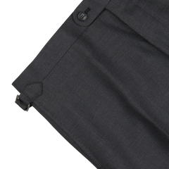 Close-up of Baltzar Sartorial Grey Super 100's Wool Flat Front Suit Trousers with a detailed view of the waistband, featuring a button closure and an adjustable side tab.