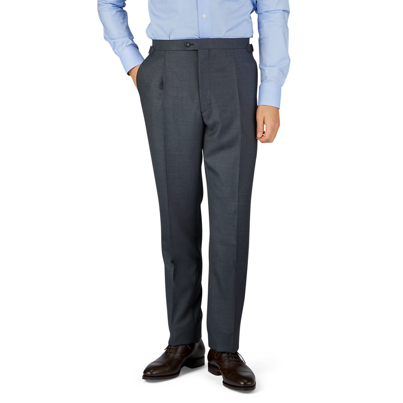 Man in a light blue shirt and Grey Super 100's Wool Pleated Suit Trousers by Baltzar Sartorial standing against a neutral background.