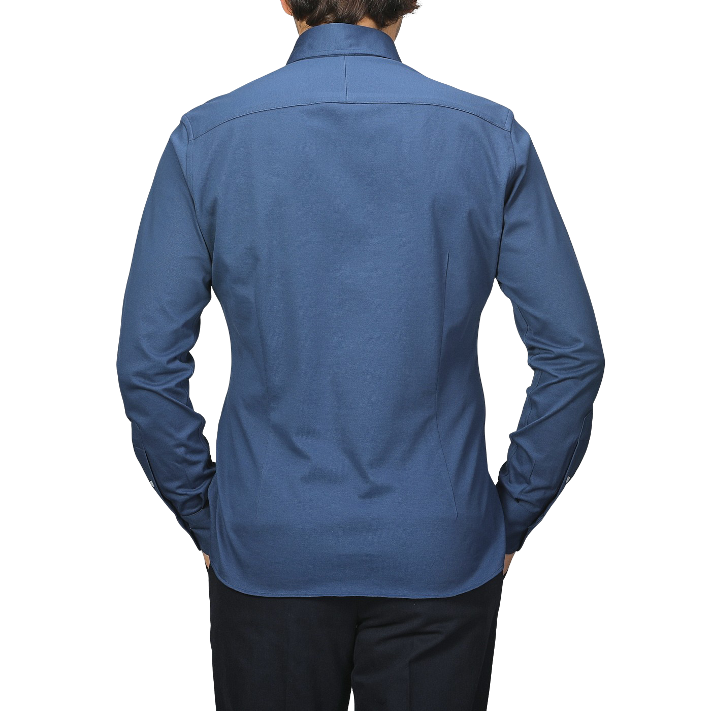 Someone is seen from the back against a plain background, wearing an Indigo Blue Cotton Piqué BD Popover Shirt by Baltzar Sartorial and black pants.